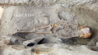 A skeleton from a child who died between age 5 and 9, left unceremoniously in a quarry pit and covered in debris. (Image: The Gebel el-Silsila Project 2017)